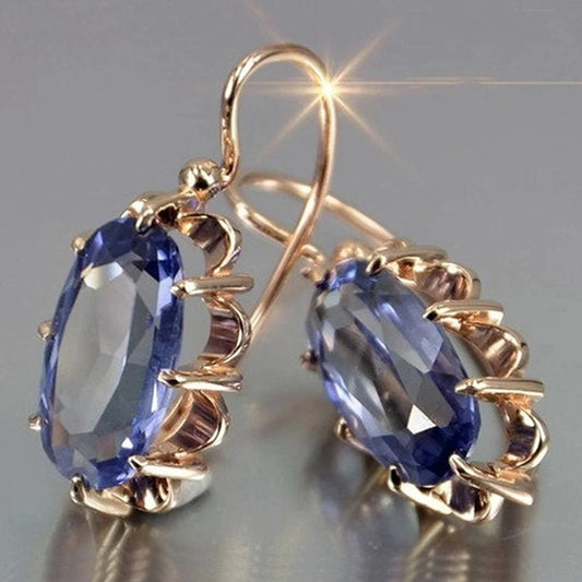 Elegante Hakenohrringe mit ovalem, facettiertem blauem Edelstein
